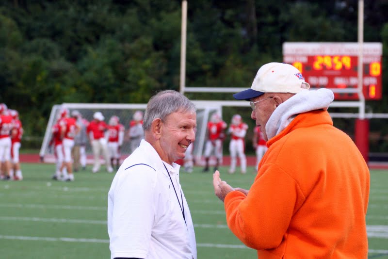 Head Coach Barry Greener shares a laugh with Rebel legend John Lee.