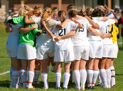 Walpole Girls Soccer team huddle together getting ready for their game against Dedham on Thursday, October 1. 