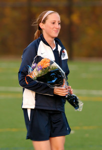 Senior Erin Swanson walks back to her team after recieving flowers on Senior Day.