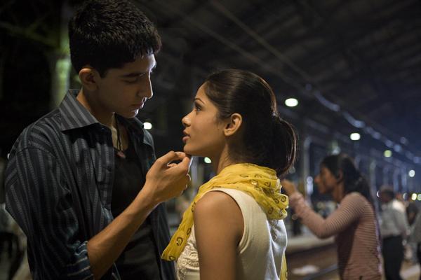 Jamal (Dev Patel) and Latika (Freida Pinto) reunite at a train station.