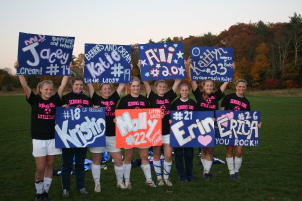 Walpole Girls Soccer seniors hold up the signs that were made for them on Walpole's Senior Day October 29.