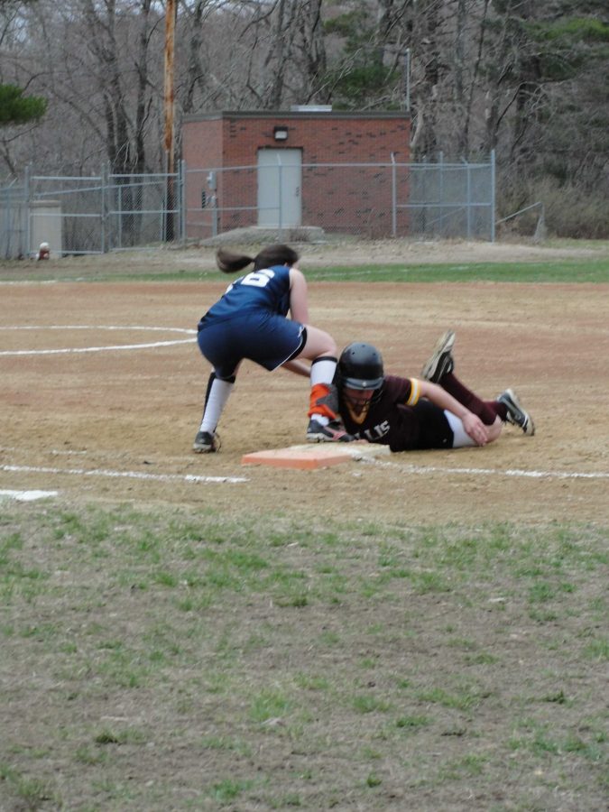 The Walpole catcher successfully gets the ball to first base to pick off a Millis runner.