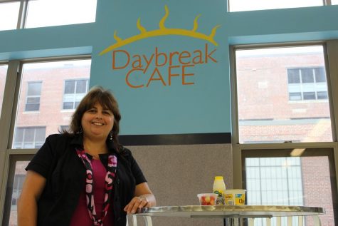 Maria Hall poses with new healthy food options available at the new daybreak cafe.