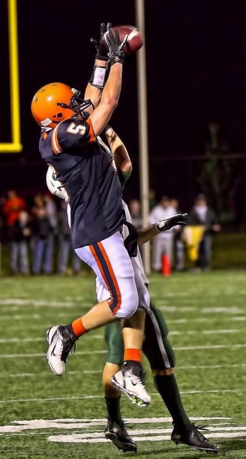 A+Walpole+receiver+goes+up+and+over+a+Dennis-Yarmouth+defender.+%28Photo%2FTim+Hoffman%29