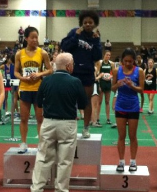 A Walpole athlete receives first place for long jump. (Photo/Conor Cashman)