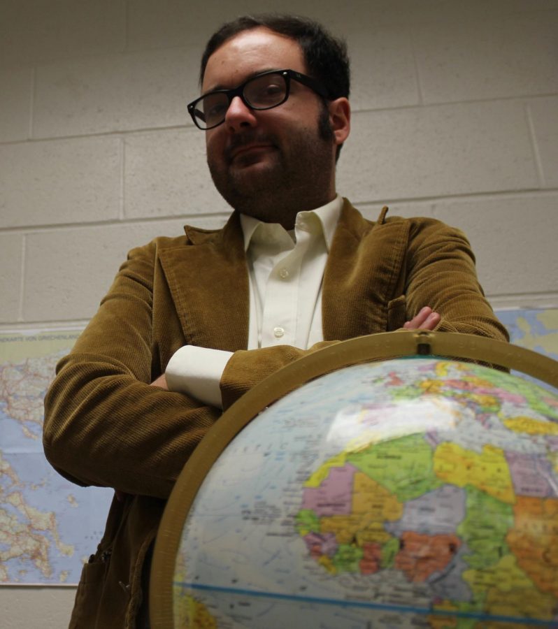 Advisor of Global Studies Mr. Bakale and his globe. (Photo/Dana Morrone)