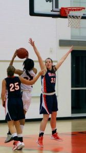 A Walpole player attempts to block a Wildcats' shot.