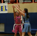 A Walpole player defends a Medfield player.