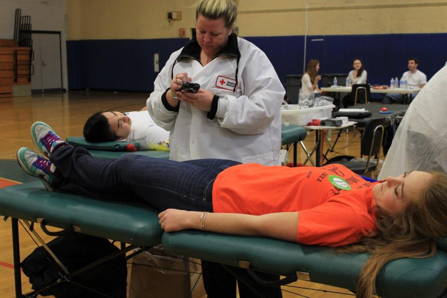 A Walpole High Student donates blood to Red Cross