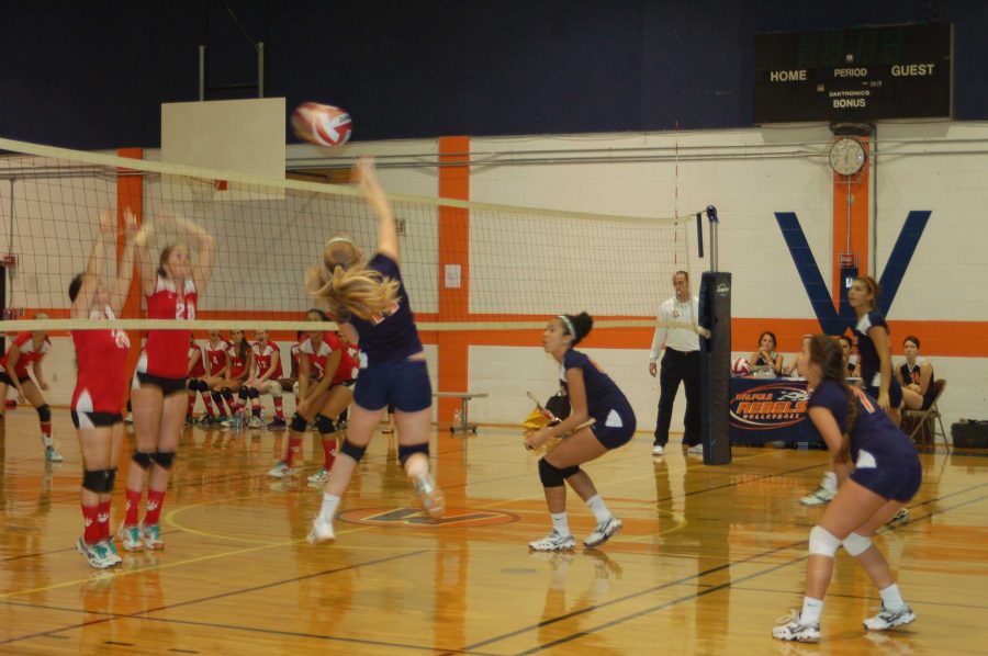 Walpole Senior Attempts a Kill Against Milton Blockers.