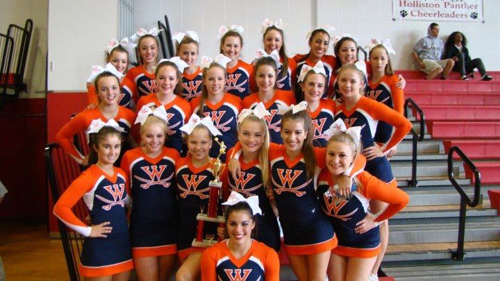 Rebel Cheerleaders celebrate with their trophy after the presentation of awards. 