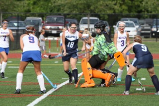 A Walpole player attempts to score on an opposing goalie.