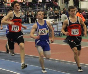 The 1000m racers come around to the fifth and final lap of the race.