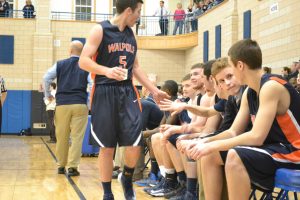 Senior Captain Johnny Adams congratulates his teammates.