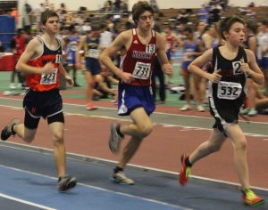 A senior racer competing in the mile finishes behind a Wellesley runner.