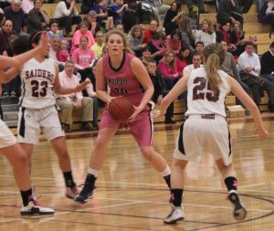 Opposing defenders pressure a Walpole player.