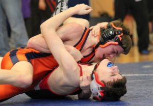 The Rebel's 106 pounder works to pin his opponent. 