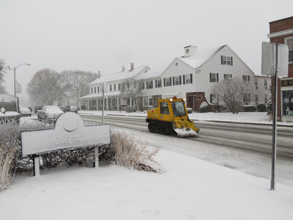 A plow trails through the center of town.