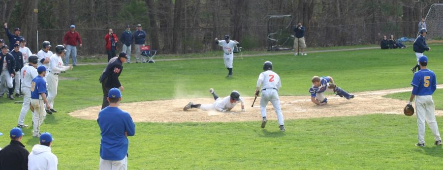 Senior Outfielder slides into home safely for a grand slam. 