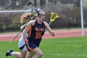 A Walpole player looks to transition into offense after picking up a ground ball.(Photo/ Mary Barry)