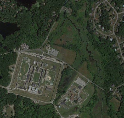 The large square of land is the Walpole prison, with the fields being the lighter green land in the center of the photo.