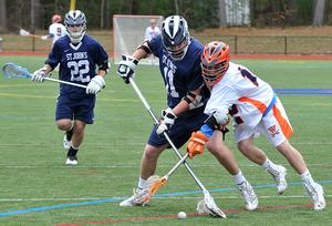 Senior Chris Frye fights off a St. Johns Prep opponent for the ball