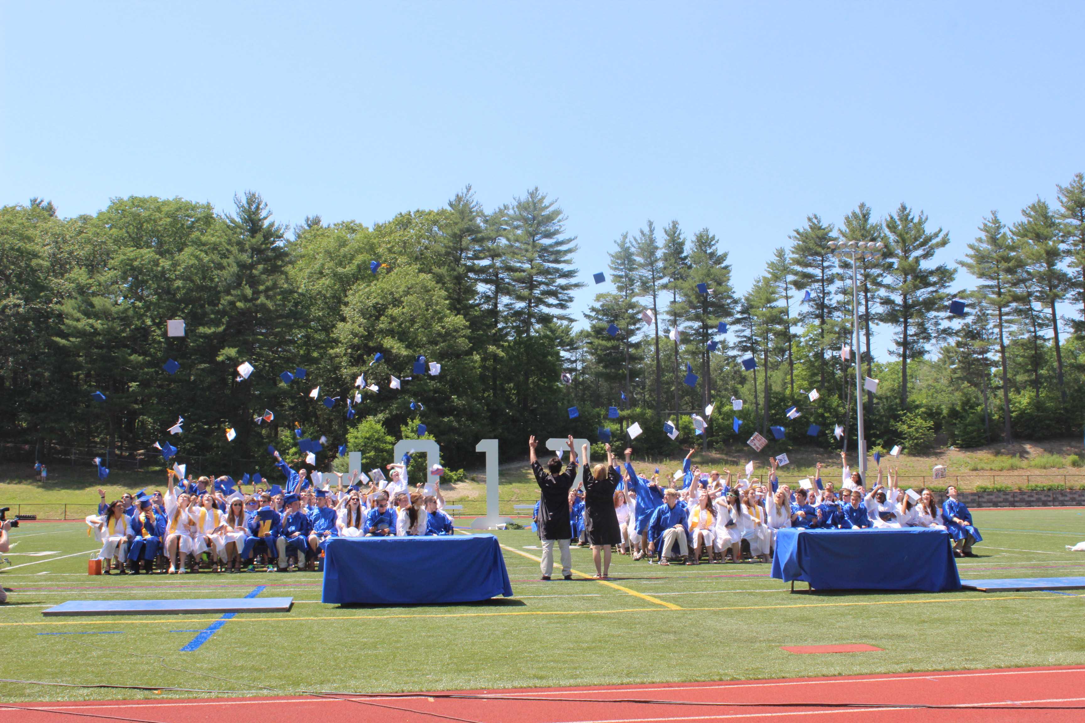 The members of the Class of 2013 throw their caps in the air in celebration after graduating.