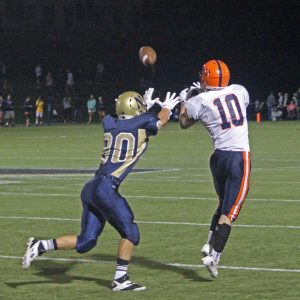 A senior wide reciever goes to make the catch.
