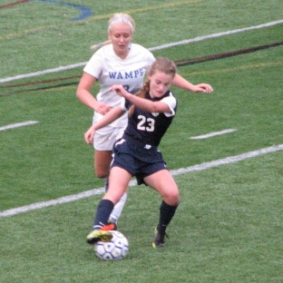 Senior Captain Abbey Smith maintains control of the ball against a Braintree defender. 