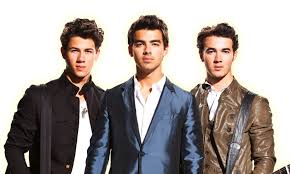 Nick, Joe, and Kevin pose for a photo as The Jonas Brothers.