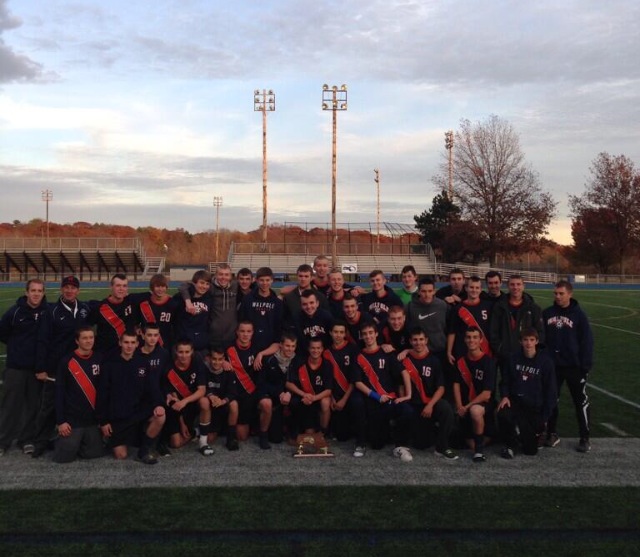 The Boys Soccer Team celebrates with the South Sectional trophy without touching it. (Photo/ Mike Gruelich)
