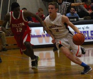 A Walpole guard drives to the basket.