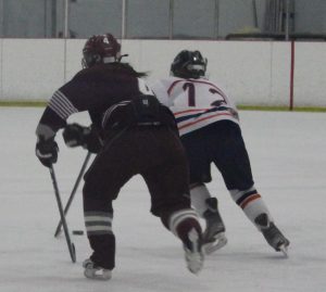 A Rebel attacker skates her way to the first Walpole girl of the night.