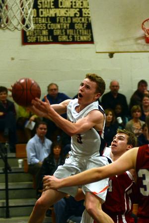 A Walpole guard drives to the basket.