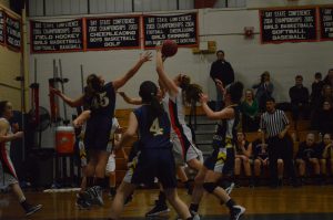 Walpole's center goes up for a shot.