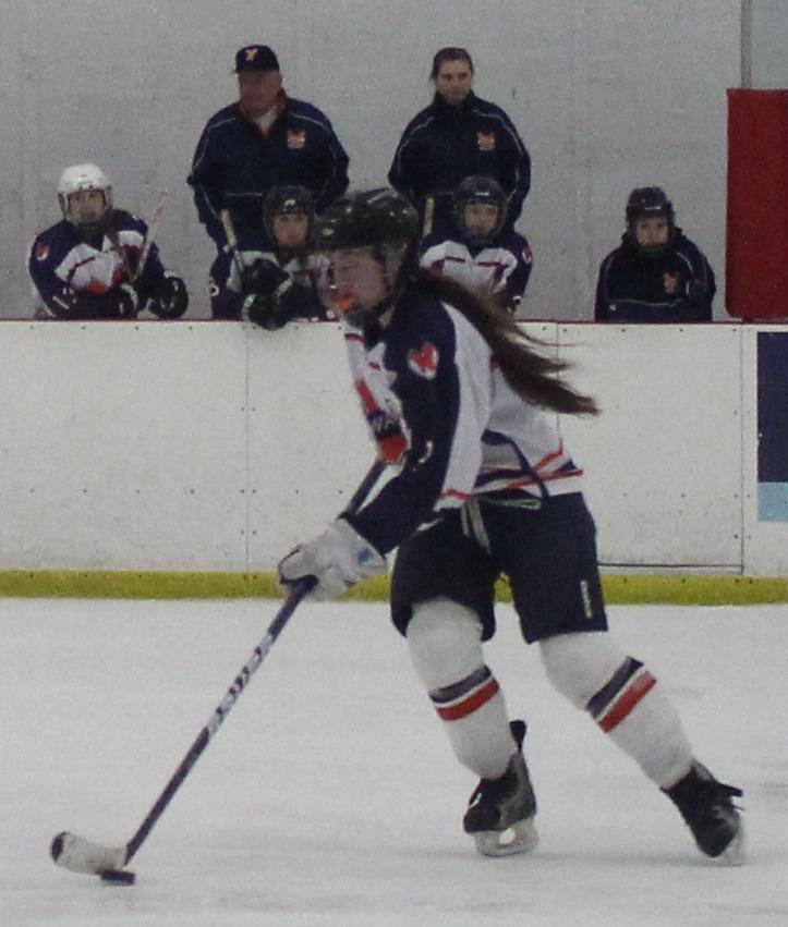 A Rebel brings the puck down the ice.