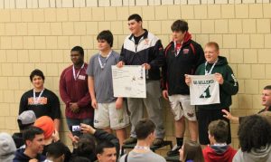 The Rebel's Heavyweight poses atop the Sectional Championship podium after pinning Milford in double OT. 