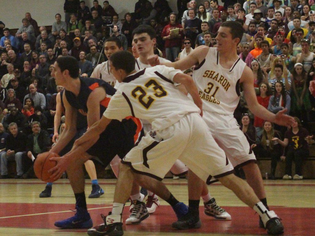 Sharon defenders swarm a Walpole basketball player.  (Photo/ Julia Adams)