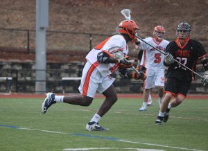 A Walpole midfielder attacks a Newton North defender. 