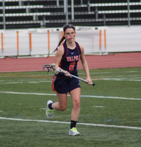 A rebels midfielder goes down the field in an attempt to score.