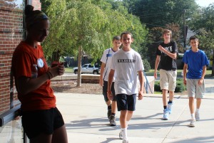 A Student Council member welcomes incoming freshmen as they arrive at Orientation.