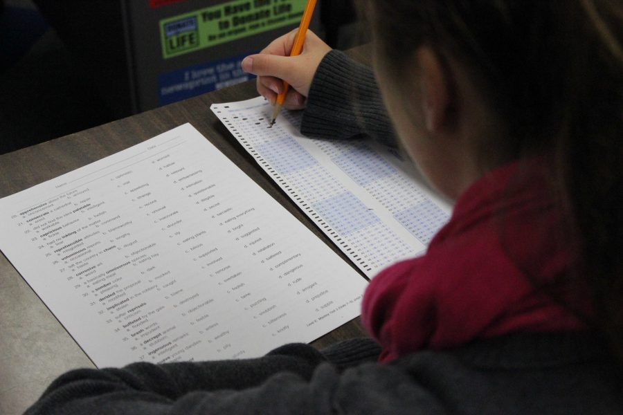 A student takes an exam during class.