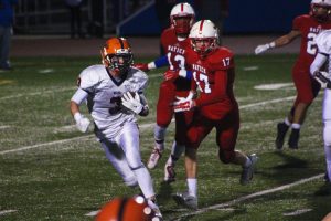 A Rebel wide receiver runs to avoid the Natick secondary. 
