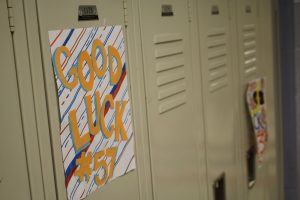 Walpole Cheerleaders decorate the Football players lockers with encouraging posters.