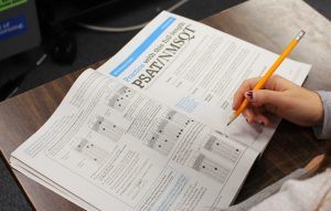 A student fills out the sign-up forms for the PSAT. (Photo/ Lauren Wigren) 
