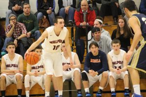 A Walpole athlete dribbles the ball in a game against Needham.