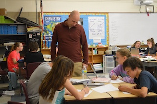 Mr. Kujawski oversees his students doing an activity about the light spectrum on the computers. (Photo/ Cameron Johnson)