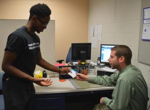 Mr. Hand excuses a student from a tardy-related detention