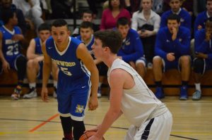 Junior guard Luke Esty takes a foul shot during Walpole's game against Norwood. Photo/Ellie Kalemkeridis