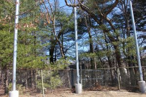 The confederate flag no longer flies on the neighbor's property. Currently, there are no plans for how to use the Walpole School Committee poles, previously used to hang banners to block the flag. (Photo/ Max Simons)